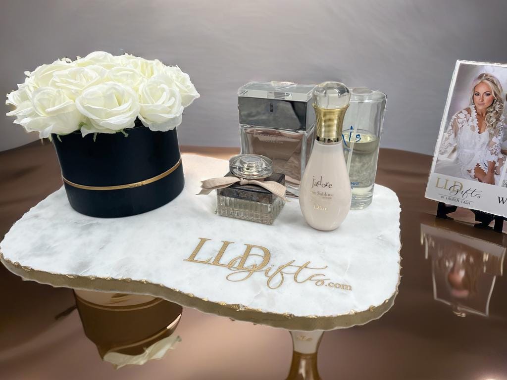 a table topped with a vase filled with white flowers