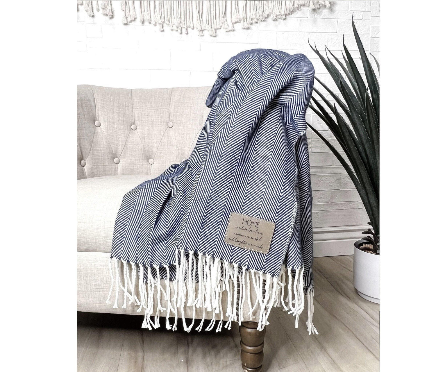 Our farmhouse throw blanket is adorned with a soft herringbone pattern and tassels at each end. The laser-engraved leatherette patch can be customized with your own message or company logo, and is applied in the corner for a personalized touch.