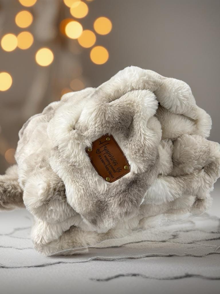 a white stuffed animal with a tag on it
