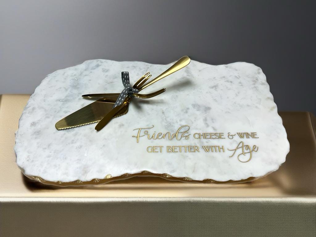 a white marble plaque with a gold knife on it