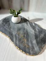 a white vase with a green plant in it
