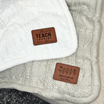 a close up of a sweater with a tag on it