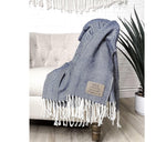 Our farmhouse throw blanket is adorned with a soft herringbone pattern and tassels at each end. The laser-engraved leatherette patch can be customized with your own message or company logo, and is applied in the corner for a personalized touch.