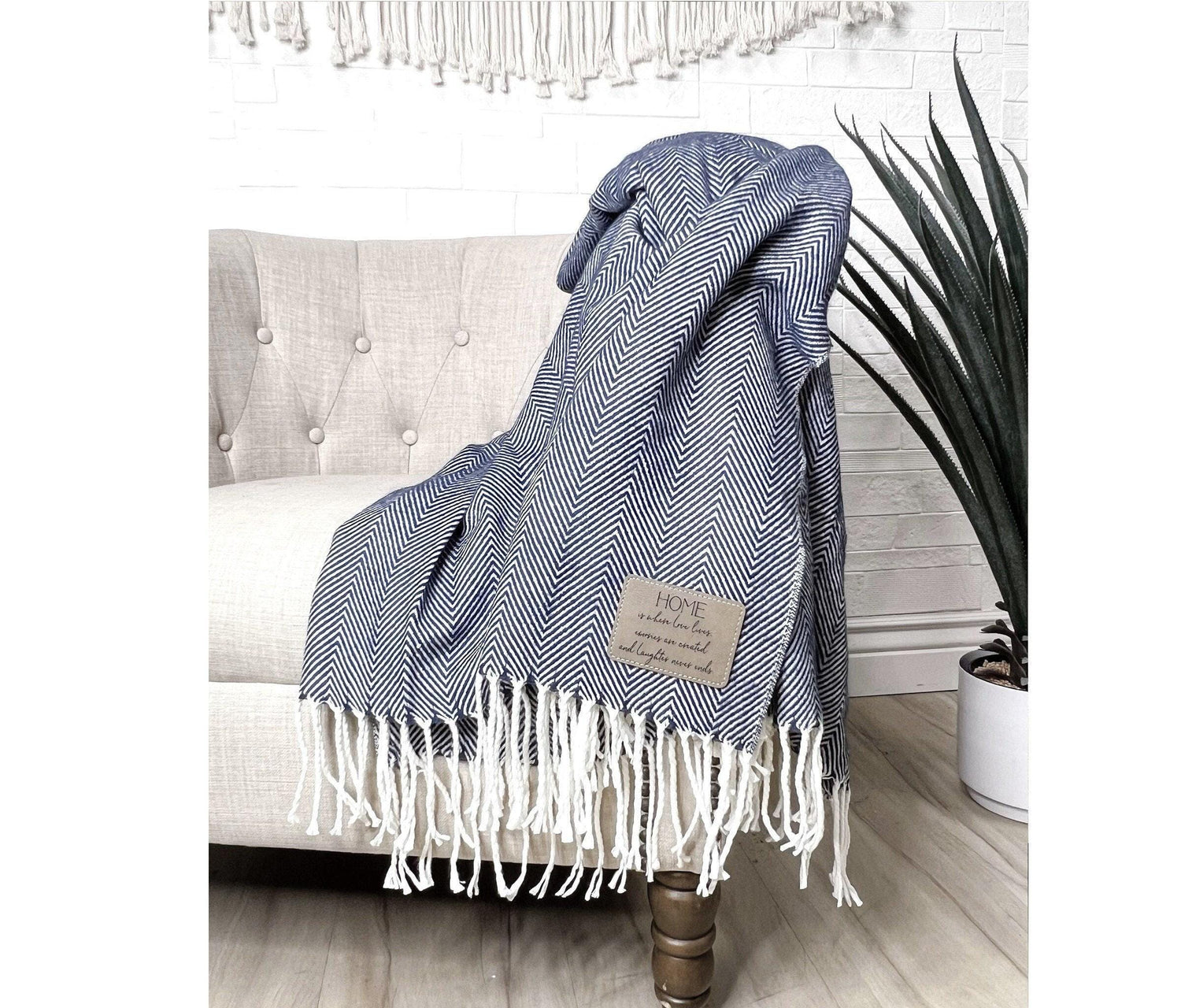 Our farmhouse throw blanket is adorned with a soft herringbone pattern and tassels at each end. The laser-engraved leatherette patch can be customized with your own message or company logo, and is applied in the corner for a personalized touch.