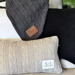a pile of pillows sitting on top of a couch