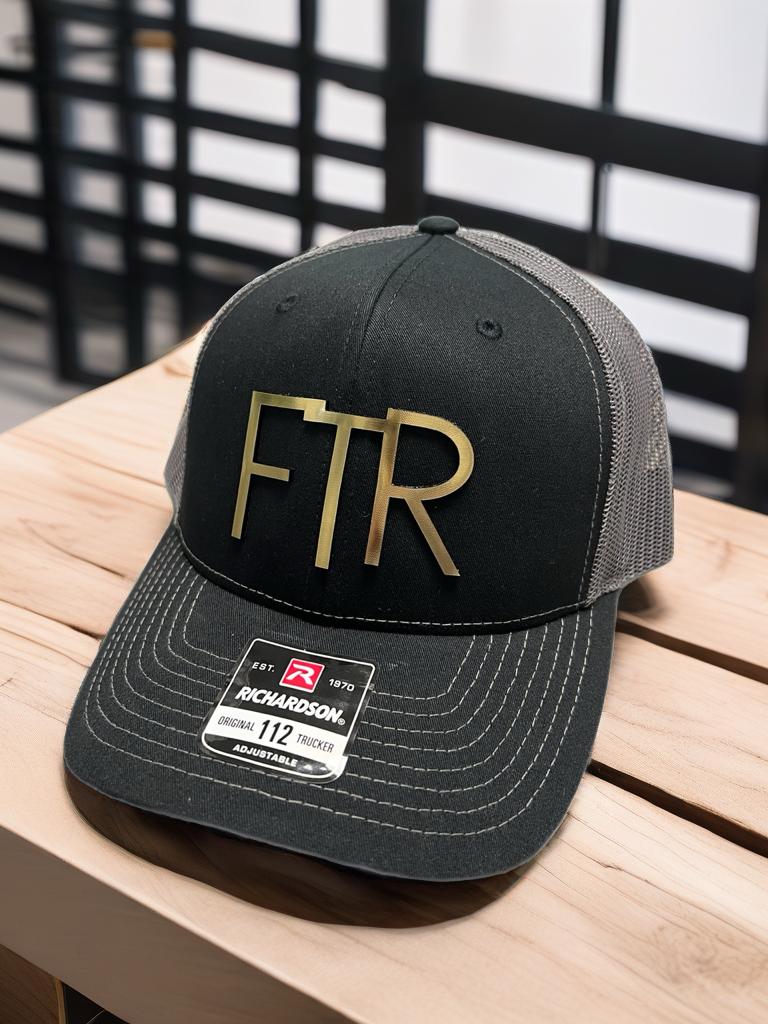 a black and gold hat sitting on top of a wooden table